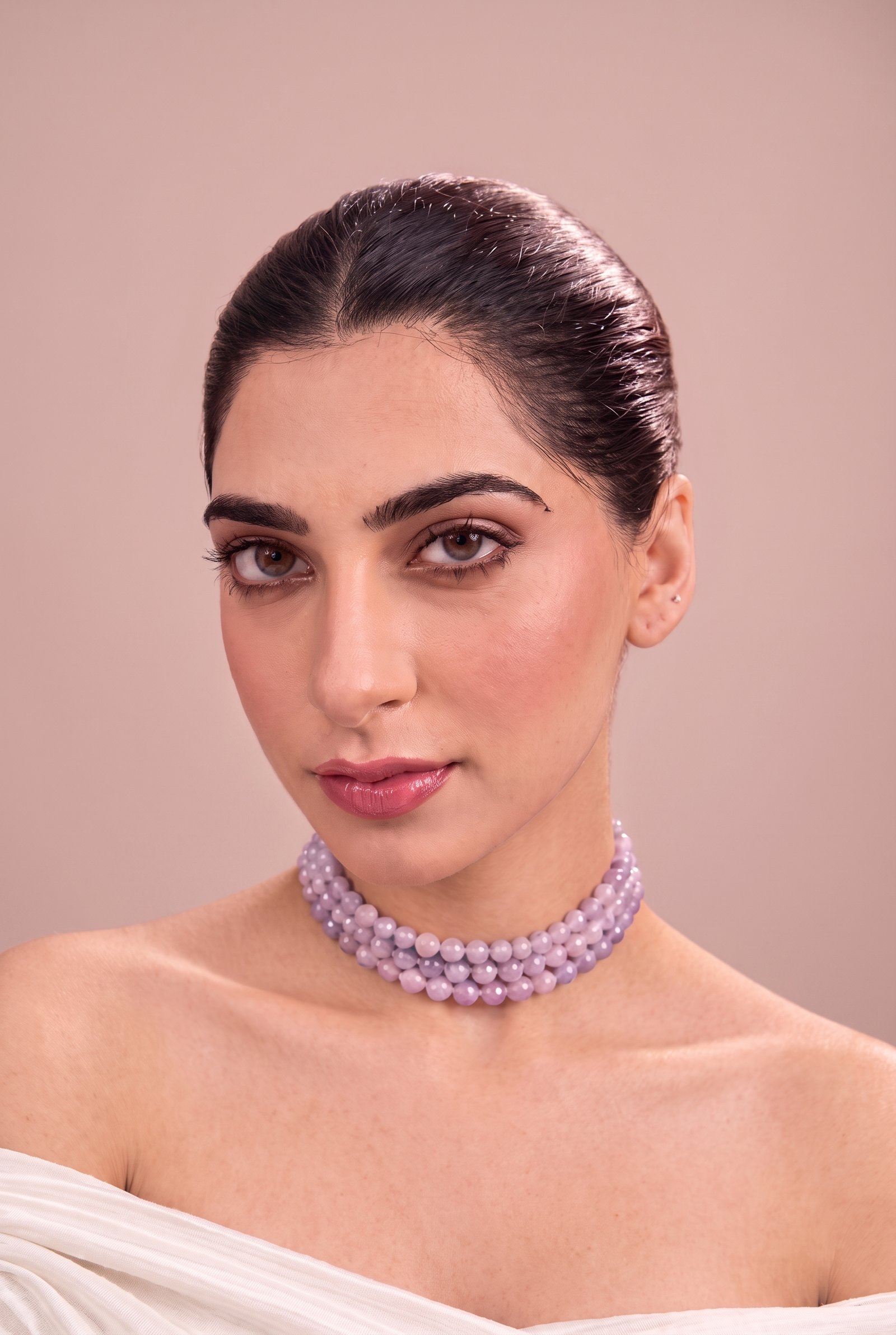 A woman in a white off-shoulder drape wearing the Blush Kunzite Trio lilac bead choker