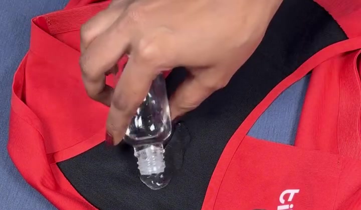 Liquid being poured onto the gusset of red seamless underwear