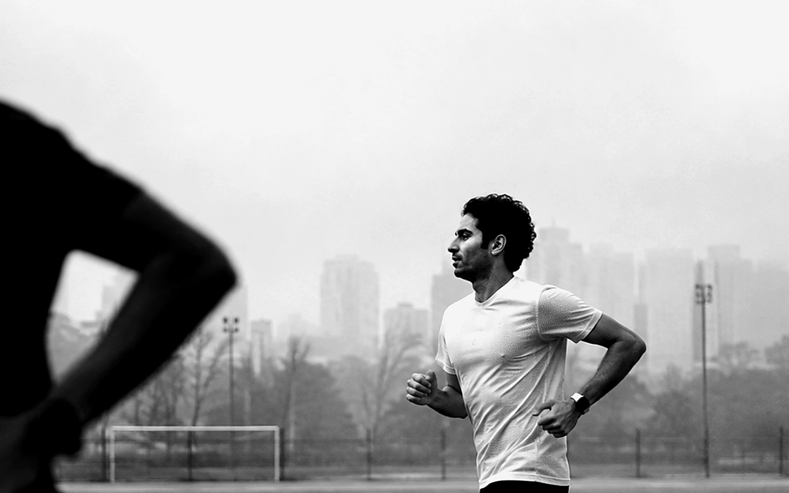 Two Rivet Running athletes training through a monochrome track study
